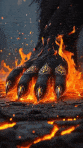 a monster 's paw is surrounded by flames and looks like it 's on fire