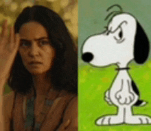 a woman is standing next to a picture of snoopy the dog .