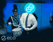 a man in a marching band playing drums with a blue logo on his head that says eco