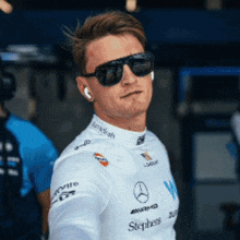 a man wearing sunglasses and a white shirt with the word stephens on it