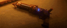 a close up of a gun on a brown surface