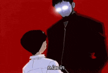 a man in a black jacket is standing next to a boy in a white shirt and talking to him .