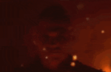 a close up of a man 's face with glasses and a mustache .