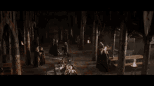 a man with long blonde hair is standing in front of a group of men
