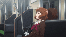 a girl in a school uniform is sitting on a train with her eyes closed