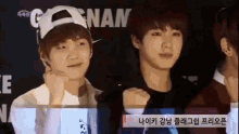 a group of young men are standing in front of a sign that says nan