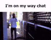a man walking down a hallway with the words i 'm on my way chat