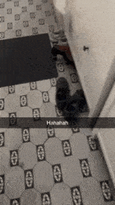 a snapchat of a person 's shoes on a tiled floor with a caption that says ' hahahah '