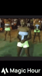 a group of people are dancing in front of a sign that says " magic hour "