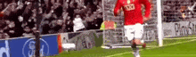 a soccer player wearing a red shirt with the word sgc on it