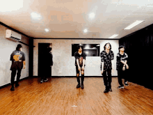 a group of people are dancing in a room and one of them has a t-shirt that says ' a ' on it