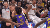a basketball player with the number 11 on his jersey is being fouled by another player