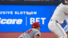 a baseball player with the number 33 on his back catches a ball