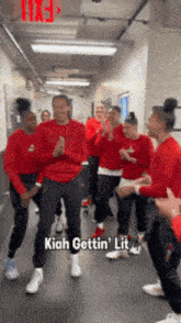 a group of people dancing in a hallway with the words kiah gettin ' lit