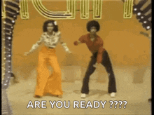 a man and a woman are dancing on a stage and the man is saying `` are you ready ? ''