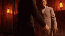 two men shaking hands in a dark room