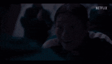 a man wearing a jacket with the number 456 on it talks to a woman