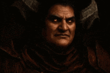 a man with horns on his head is smiling