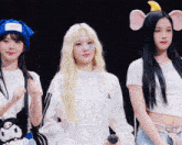 three girls standing next to each other with the word ld on the bottom right