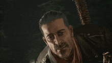 a man in a leather jacket is holding a weapon and asking buddy you still there