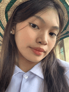 a girl wearing a hat and a white shirt