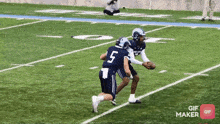 a football player with the number 5 on his jersey is being tackled by another player