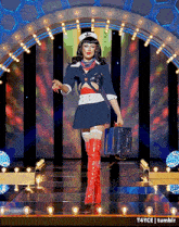 a woman in a sailor costume is walking down the runway