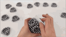 a person is holding a bunch of metal balls in their hand