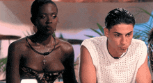 a man and a woman sitting next to each other