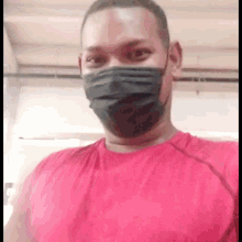 a man wearing a mask and a red shirt