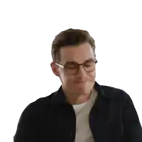 a man wearing glasses and a black shirt smiles