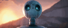 a close up of a robot 's head with a sunset in the background