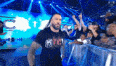 roman reigns is walking out of the ring at a wrestling match .