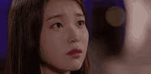 a close up of a woman crying with a tear coming out of her eye .