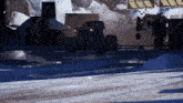 a monster truck is driving through a snowy area