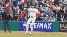 a baseball player in a guardians jersey runs towards home plate
