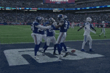 a group of giants football players celebrate a touchdown during a game