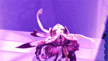 a purple background with a purple flower in the middle