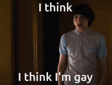 a young man is standing in a dark room and says i think i think i 'm gay