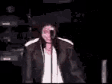 a blurry picture of a man dancing on a stage in a dark room .