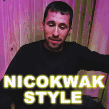 a man wearing a black shirt with the words nicokwak style written on it