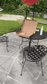 a pizza box is sitting on a table outside