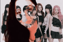 a group of girls are standing next to each other in front of a red flame