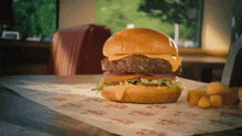 a hamburger and french fries on a table with a sign that says ' a ' on it