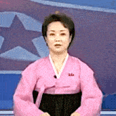 a woman in a pink kimono with the letter l on her chest