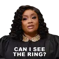 a woman in a judge 's robe says can i see the ring