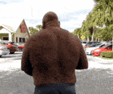 a man is standing in front of a restaurant called golden coconut