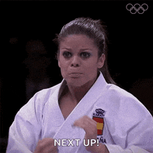 a woman in a karate uniform is saying " next up "