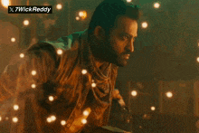 a man is surrounded by sparks with a 7wick reddy sticker above him