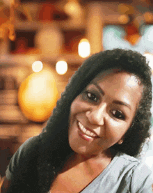 a woman with long hair smiles for the camera